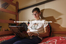 A student uses their laptop to study in their University Suites Residence Hall room. Housing Photo S