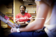 Students socialize in a University Suites Residence Hall room. Housing Photo Shoot in University Sui