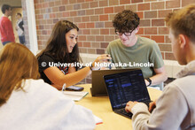 Students studying in a commons area in University Suites Residence Hall. Housing Photo Shoot in Univ