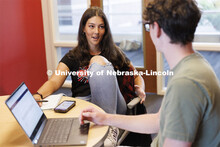 Students studying in a commons area in University Suites Residence Hall. Housing Photo Shoot in Univ