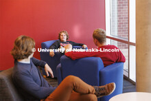 Students socializing in a commons area in University Suites Residence Hall. Housing Photo Shoot in U