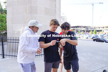 Three Sigma Epsilon Phi students look read their clue at the Homecoming Traditions Race. The Traditi