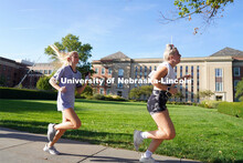 Members of Tri-Delta Sorority sprint past Love Library towards the finish line at the Homecoming Tra