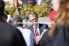 Chancellor Ronnie Green talks with people on R Street attending the all-employee picnic. The picnic 