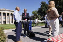 Chancellor Ronnie Green talks with people on R Street attending the all-employee picnic. The picnic 