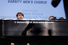Peter Eklund’s shadow falls on the side of the piano as he directs the Varsity Men’s Chorus to o