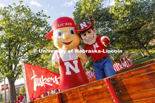 Herbie Husker and Lil’ Red in a trailer pulled by Jake Jundt a former Husker Cheer squad member an