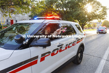 Captain Aaron Pembleton throws candy to spectators as the UNLPD leads the homecoming parade. Homecom