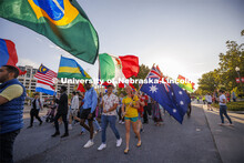 International students carry their flags in the Homecoming Parade and Cornstalk. September 30, 2022.