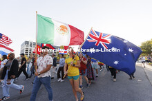 International students carry their flags in the Homecoming Parade and Cornstalk. September 30, 2022.