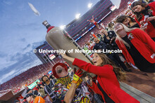 Soon-to-be-crowned homecoming royalty Emily Hatterman fires a hot dog into the crowd from Der Viener