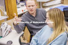 Assistant Professor Matthew Miller critiques student's projects. Design studios in Architecture Hall