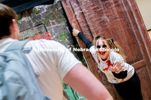Student and performer, Madison Garrow, greets students as they enter the haunted house at the Husker