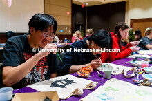 Students, Kevin Nguyen (left) and Thomas Dinh (right), paint tote bags at the Husker Haunt in the Ne