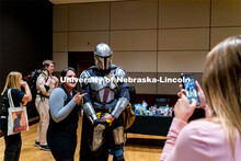 Students pose with Ben Ferguson dressed up as the Mandalorian at the Husker Haunt in the Nebraska Ea