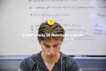 Student with a rubber duckie on his head. Students working in a classroom. Raikes School photo shoot