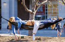 Camille Smith and Carly Tapson lounge in the hammocks outside the Nebraska Union on an unseasonably 