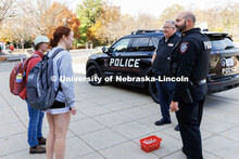 Captain Aaron Pembleton, right, and Marty Fehringer, Assistant Chief of Police, talk with students a