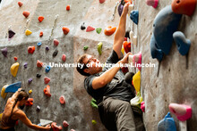 Students climb a boulder route during the League of Extraordinary Boulderers. League of Extraordinar