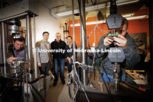 Husker Engineers Jongwan Eun (center left), Yuris Dzenis (center) and Seunghee Kim (center right) po