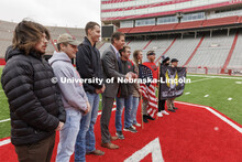 Nebraska Athletic Director Trev Alberts hands over the game ball that will be part of the Ruck March