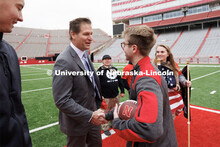Nebraska Athletic Director Trev Alberts shakes hands with Ruck March organizer Everett Bloom after p