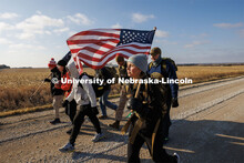Midshipman Abby Thibodeau and other Ruck Marchers trek along Holdrege Street in rural eastern Lancas