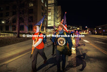 Midshipman Cohan Bonow, right, and UNL alumni and veteran Connor Williams trek along Vine Street wit