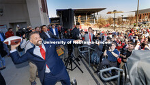 Husker head football coach Matt Rhule throws out one of five footballs to the crowd outside East Sta