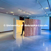 Chris Nguyen examines his panels of Eastern Red Cedar. The panels are part of his project to find us
