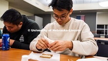 Students, Andre Nguyen (right) and Corey Nguyen (left), work together building a gingerbread house. 