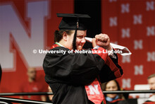 College of Business Management graduate Zachary Molzer gestures for the live-stream cameras. Winter 
