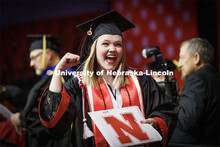 Kaylie Trumble, a Speech-Language Pathologist graduate, shows off her diploma to the Husker Vision c