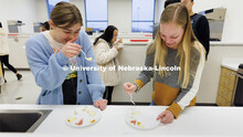 Amanda Maliva, left, reacts to the strong flavor of the cheese as she and Alisa Holst sample various