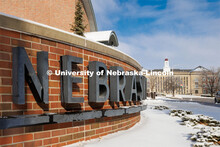 Close up of the sign out front of the Van Brunt Visitor’s Center. Ice and snow cover campus. Janua