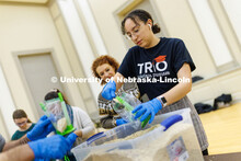 Mona Miller, a sophomore from Omaha, scoops oatmeal into bags as part of MLK Week events. Volunteers
