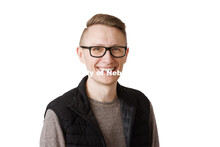 Studio portrait of Zac Franzen, Alumni Relations and Events Coordinator, College of Journalism and M