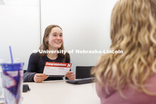 Alexis Dent, a freshman, is all smiles after working with the Explore Center’s Elisa Heide to find