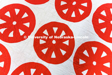 Red wagon wheels decorate the top of a quilt in the Quilt Center. February 8, 2023. 