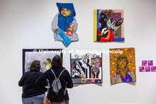 Visitors look over the quilts in the current exhibition: Uncovering Black History: Quilts From The C