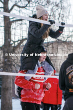 Savannah Chhen sits on top of her friends’ shoulders during a friendly game of snow volleyball Thu