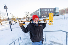 Kevin Rhodes, Area Leader with Landscape Services, pauses from clearing snow on the steps between Ca