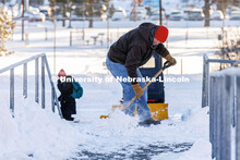 Kevin Rhodes, Area Leader with Landscape Services, pauses from clearing snow on the steps between Ca