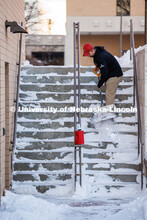 Ron Natale, Facilities Services Manager with the Lied Center for Performing Arts, clears the steps a