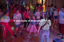 Parker Matzen leads a group of students in a dance during the 70s disco dance party portion of Huske