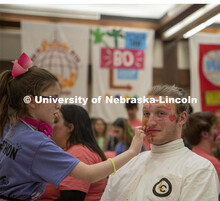 Sam DeZube gets his makeup done by Parker Malzen before performing with his band, Loose Change, duri