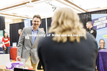 Clayton Meder talks with a recruiter at the Career and Internship Fair in Nebraska Union. February 2