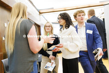 Gabby Gomez Martinez, right, and Kenidy Irvine talk with a recruiter from Charles Schwab during the 