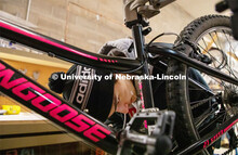 Engineering student Jacob Dalton works on repairing a bike at Lincoln Bike Kitchen Repair. The Bike 