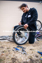 Engineering student Alejandro Marquez works on repairing a bike at Lincoln Bike Kitchen Repair. The 